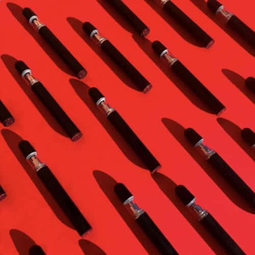Diagonal Array of Jupiter CCELL® LiquidX300 Vaporizers on Red Background